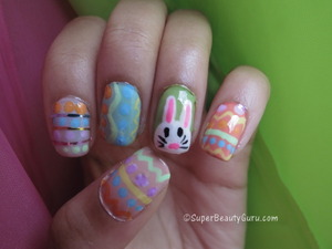 http://superbeautyguru.com/spring-makeup-using-analogous-colors-and-double-winged-liner
This Easter nail look uses pastel colors to create an adorable Easter egg and Easter bunny nail look. I used nail paint and striping tape along with nailpolish to do these nails, and have a video tutorial on my blog.
