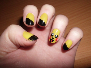 My attempt at Pikachu nails, the ring finger was copied from a nail design picture a friend sent to me, then I thought the black angled tips just fit nicely.