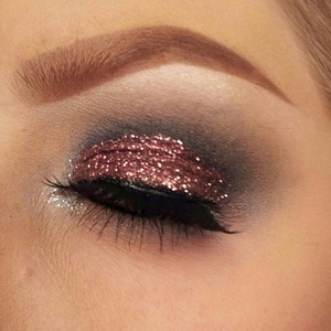 A dramatic black smokey eye with pink and silver glitter. I did this look for Last New Years Eve.