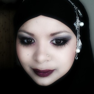 I have given a rock chick look here using greay, black, hint of pink eye shadows and dark lips and false lases to the bottom lash line and top. 