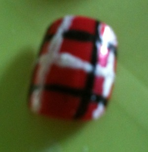 I decorated these plain red false nails using white manicure nail polish and a black nail art polish,fun and unique!