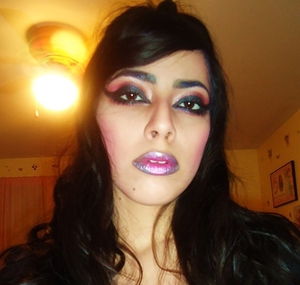 It was late at night and I was in a dark mood so this is the result of that! lol
Just a really dramatic cat eye with Pinky reddish shadow on the eyes, silver, purple and pink on the lips!