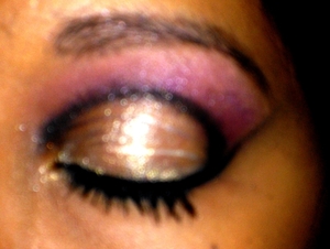 used gold cream shadow, black eyeshadow, fuschia eyeshadow, purple to accentuate the crease, and bone shimmer shadow for under the brow, black eyeliner to define