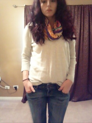 Grey light sweater, jeans, silk scarf, oxblood riding boots with natural hair...