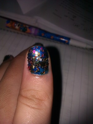 Base coat with a blue metallic nail polish and sprinkle chunky glitter on top!