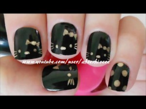 Cute and easy Hello Kitty nails with black and gold polishes =)
