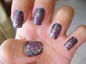 With a base colour of shimmering black, a light silver, a pale green, a bright pink and a glitter coat, there you go, galaxy nails ;)