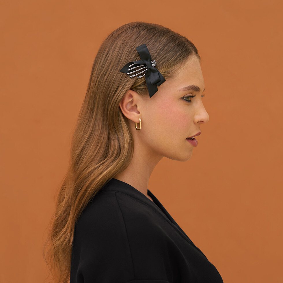 Model wearing Kitsch Skeleton Flat Claw Clips