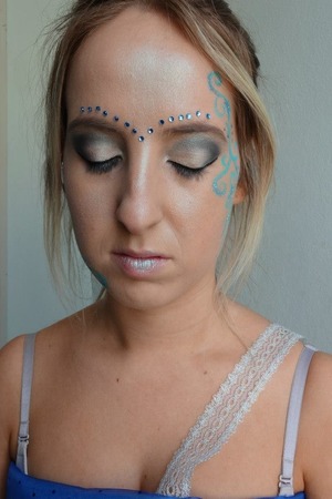 Basic eye makeup with face paint swirls on the side of the face 