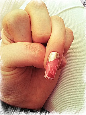 White, red & pink nail polishes water marbled on to nail.
Gold foil effect polish paited on for effect once dry.