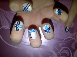 white nails with blue and black stripes