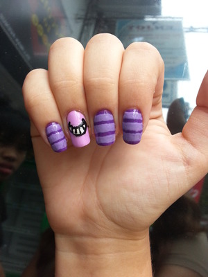 Nail art inspired by Alice in Wonderland's Cheshire Cat