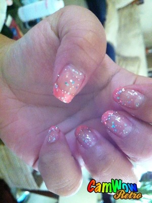 pink french tips with glitter chunks . 
