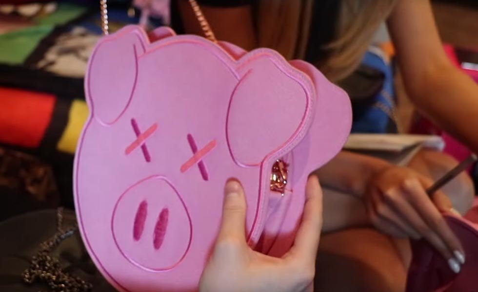 Shane Dawson Pig Side Bag with a rose gold-colored chain.