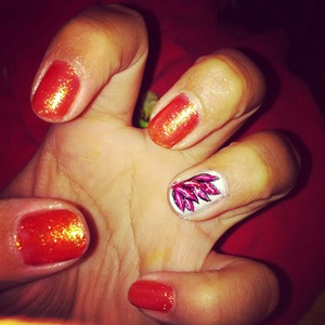 Orange base colored nails with a fall leaf designed on the ring finger nail.