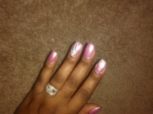 light pink polish with white stripes, silver glitter, and clear rhinestones