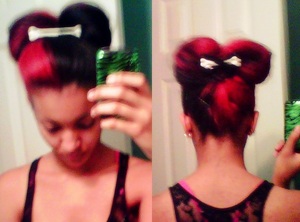 My attempt at a "hair bow" mostly held up by a black PVC bow with a bone in the back, and accented by a bone clip in the front. Taken with my blackberry, sorry about the quality.