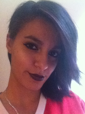 Deep eyeliner and black liner with purple and red lipstick 