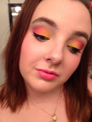 Bright neon pink, orange, and yellow on the lid. Hot pink cheek and lip. :)