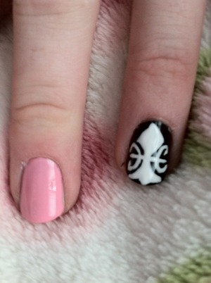 created with light pink nails, and the ring finger black using white polish and a nail art brush to created the design then used UV polish for long wear and extra shine 