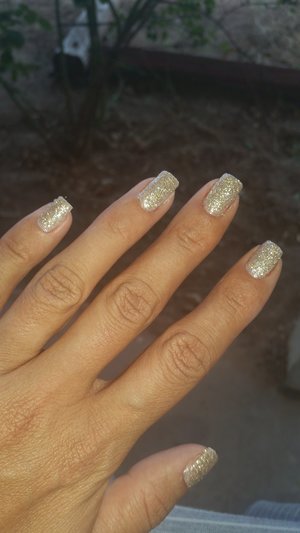 Lit Glitter in champagne wishes applied over a nude tan polish, I dip my quick dry in the glitter and covered nail (: