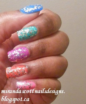 To create this Monday’s manicure I used O.P.I A Good Man-darin Is Hard to Find,  Nina Ultra Pro Blue Blaze, Nina Ultra Pro Violet it Ride, China Glaze Four Leaf Clover and China Glaze Pink Voltage. I then applied on all nails one coat of Models Own Blizzard Glitter polish.