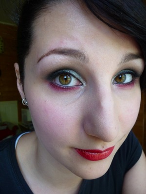 Silver and black eye shadow from the Urban Decay Naked 2,some red eye shadow, and some basic red lipstick