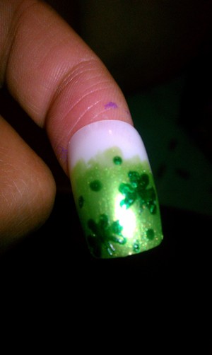 A LIGHT GREEN BASE WITH SOME DARKER GREEN DOTS AND CLOVERS GREAT FOR ST. PATRICKS DAY 
