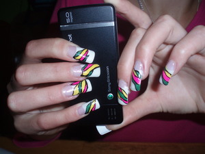 White nail tips, gel, pink, yellow, green nail varnish and black nail art pen.