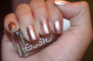 This gorgeous rose gold metallic nail polish is from Essie's new Metallics collection. The quality of the polish itself is very nice, it's very smooth and opaque and goes on with only one coat needed. It works on every skin tone: it brings out a tan in pale skin, and emphasizes those already on medium and dark skins. Because it is a rose gold, it works well with both warm and cool tones. It's an extremely wearable nail polish that I think might be the most popular from this new collection, so get your hands on one when you can. 