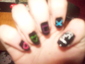 Forgive me for the picture quality again, I wanted to take a snap straight after in case it chipped or smudged when I went to sleep (painted them at night).  There is a pink circle, green triangle, purple square, blue "X" and a silver glittery PS3 on the thumbnail.