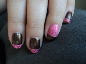 Chocolate colored nails with pink tips and brown lace art and a pink accent nail with a chocolate tip and lace art. 