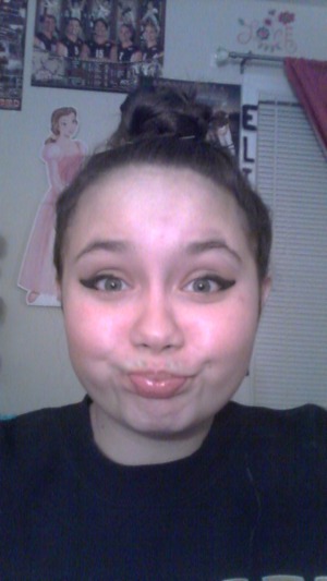 Fun little braided bun with some cute wing tipped eyeliner! :) 