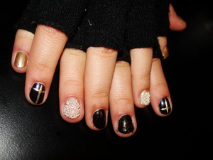 This nails have a combination of caviar and some golden, black nail polish.
