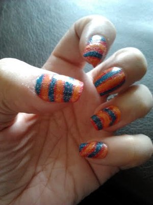 Base coat of O.P.I Cajun Shrimp, then drew lines with Nail Art brush colors, followed with N.Y.C blue glitter top coat!