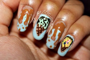 Nail Art July Day 7. ICE CREAM!! :3 I decided to paint caramel drips, mint ice cream with dark chocolate chips, & vanilla ice cream with rainbow sprinkles. The base color for this entire manicure was Sally Hansen Breezy Blue. For the caramel nails, I used a mixture of Wet n Wild Sunny Side Up and Orly Chocoholic to create the caramel, because I didn't have the perfect caramel nail polish... For the mint ice cream nails, I used Sally Hansen Mint Sorbet, and brown and black acrylic paint. And for the vanilla ice cream nails I used yellow, black and brown acrylic paint to create the ice cream & cone. I think I used like, four or five nail polishes to create the sprinkles... I believe those nail polishes were: Zoya Charisma, China Glaze Starboard, China Glaze Hang Ten-Toes & Zoya Song. 

Overall, I really like how these came out. :) 

Instagram: @Vilicious2