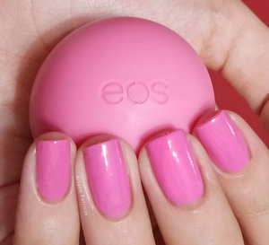 I'm holding an eos smooth sphere in the flavor Strawberry Sorbet and this is also a swatch of L.A. Colors nail polish in the shade Summertime 