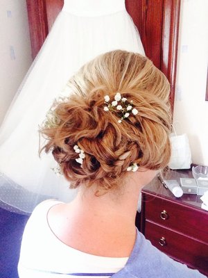 This is a bridesmaid I did, I used plaits and twists and rolls to create this look. 