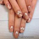 Nude nails with silver bow charm 