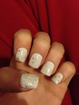 White nail polish with multi colored sparkles over