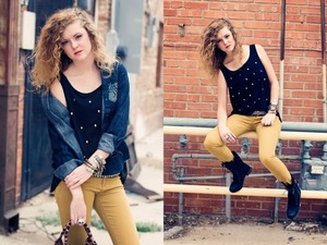 A denim shirt pulled over a studded shirt with some mustard skinny jeans and a combat boot 