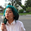 Teal haired girl with dandelion