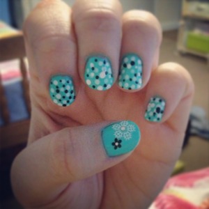 flowers on a green jelly nail polish, with black and white dots! dotting tools used 