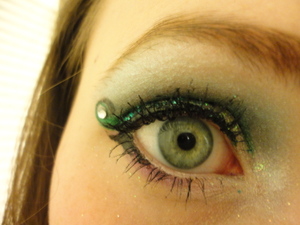 Teal glitter and black and aqua eye liner swirled at the end with a diamond like rhinestone. And of course mascara!