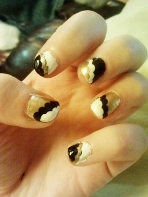 Simple gold, black and white nails in a step layered pattern