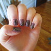 Purple, gold, and black feather nails