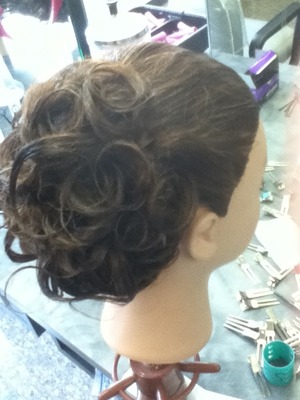 I put this hair in a roller set, combed it out, put palmate or gel in it to re form the curls and pinned them up in a bun shaped updo