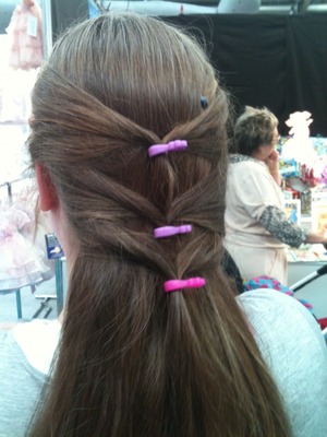 Use the adorable MINI Moni Poni ponytail holder to create this easy pulled-back ponytail style for a long and classy look