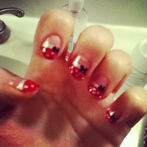 Use red nails polish just on the tip of nail, then add white dots and add a bow.