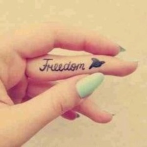 Freedom tattoo with lush nails.